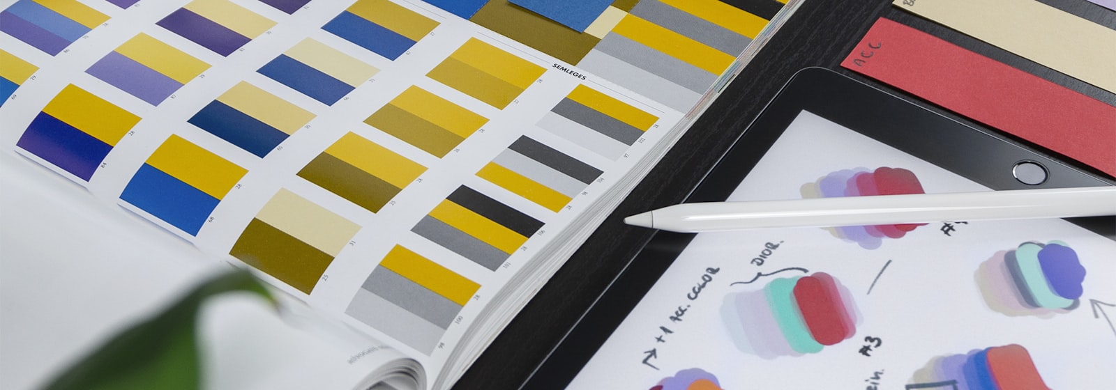Brand identity work laid out across print samples and colour swatches