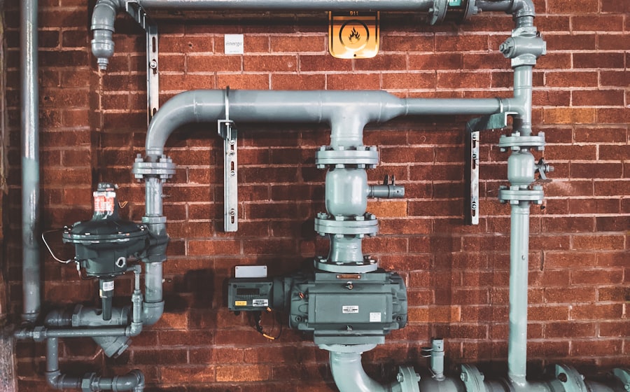 Plumber repairing pipework under a kitchen sink